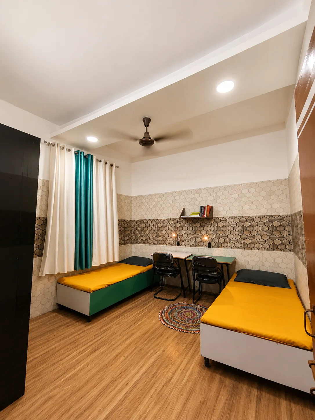 Double sharing room at Duhomes boys PG Kamla Nagar, two single beds with yellow mattresses
