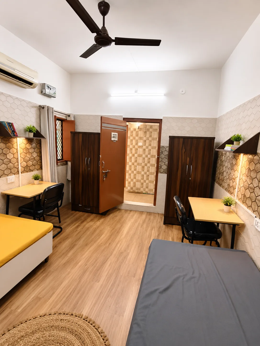 Double sharing AC room at Duhomes boys PG Kamla Nagar, fully furnished with two beds and wardrobes