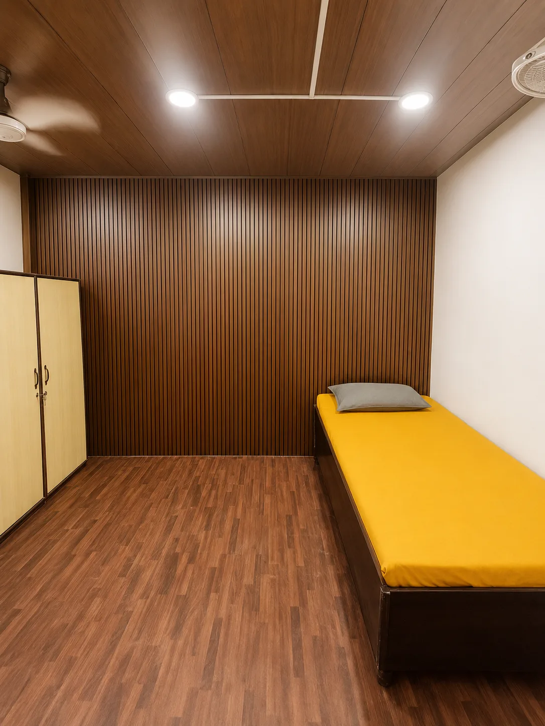 Single room at Duhomes boys PG showing bed, wardrobe and study desk
